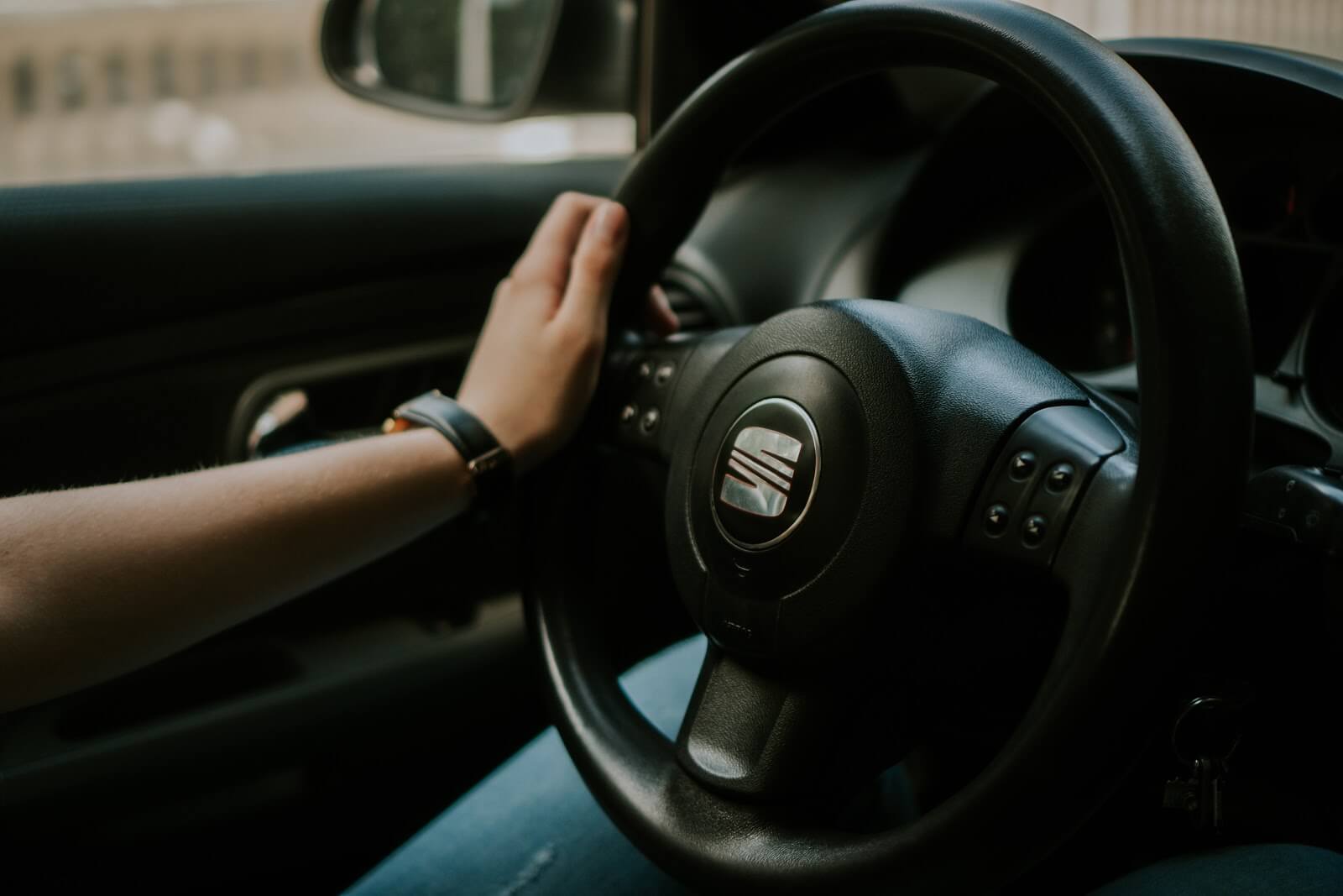 Person's hand at the steering wheel for HopSkipDrive