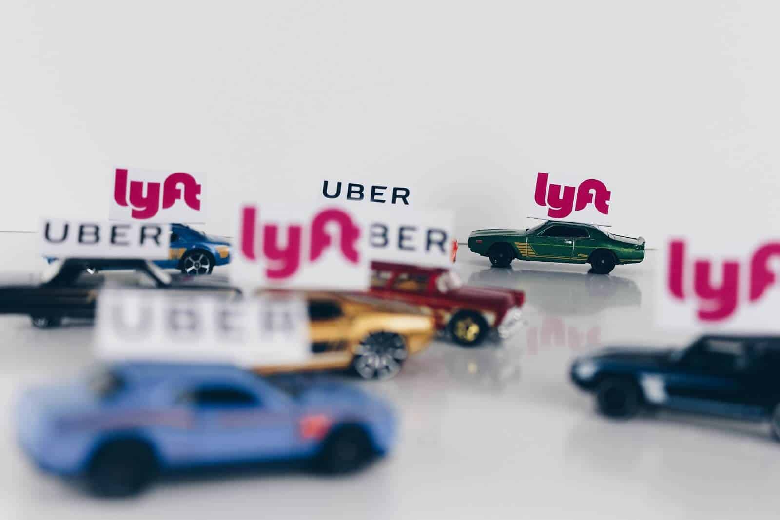 Miniature cars with Lyft and Uber signs