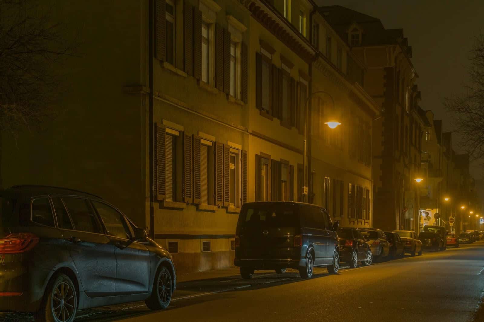 Cars parked on a dark street