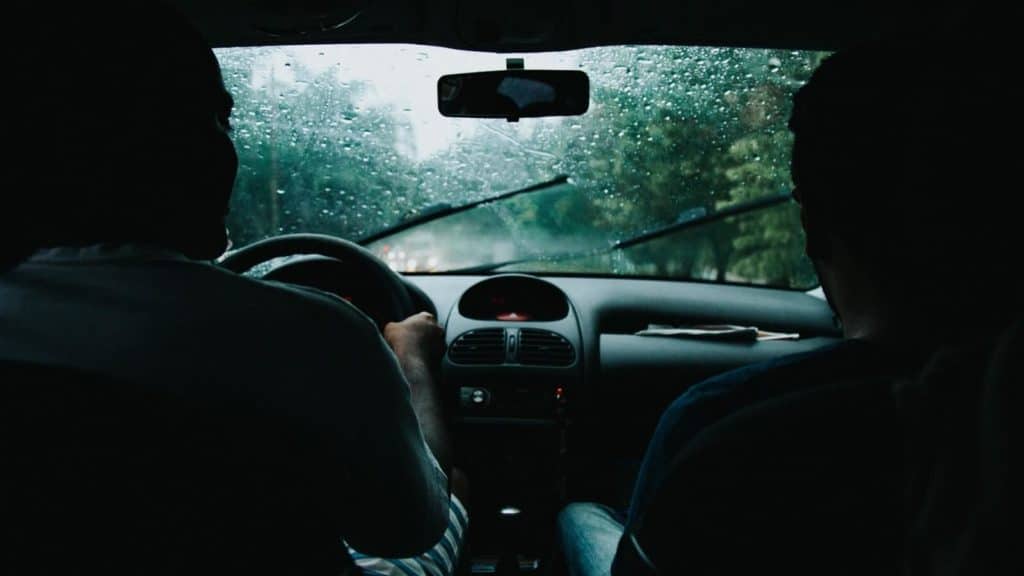 View from the backseat of a car on a rainy day
