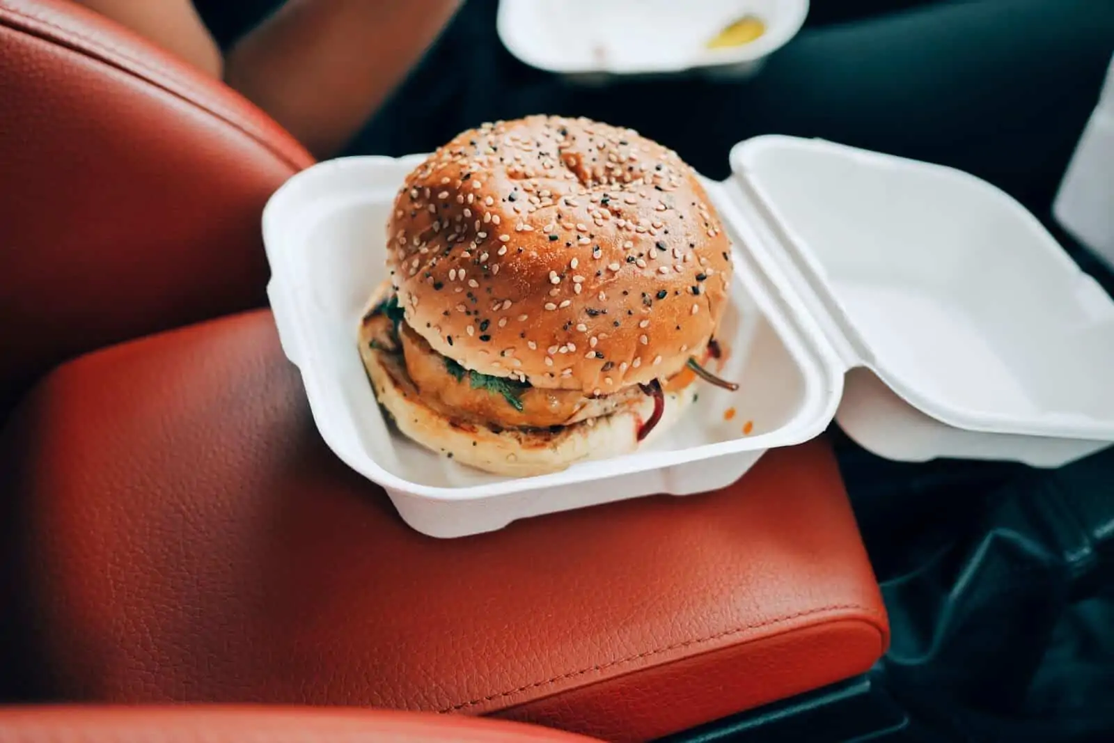 Burger in a to-go box on center console