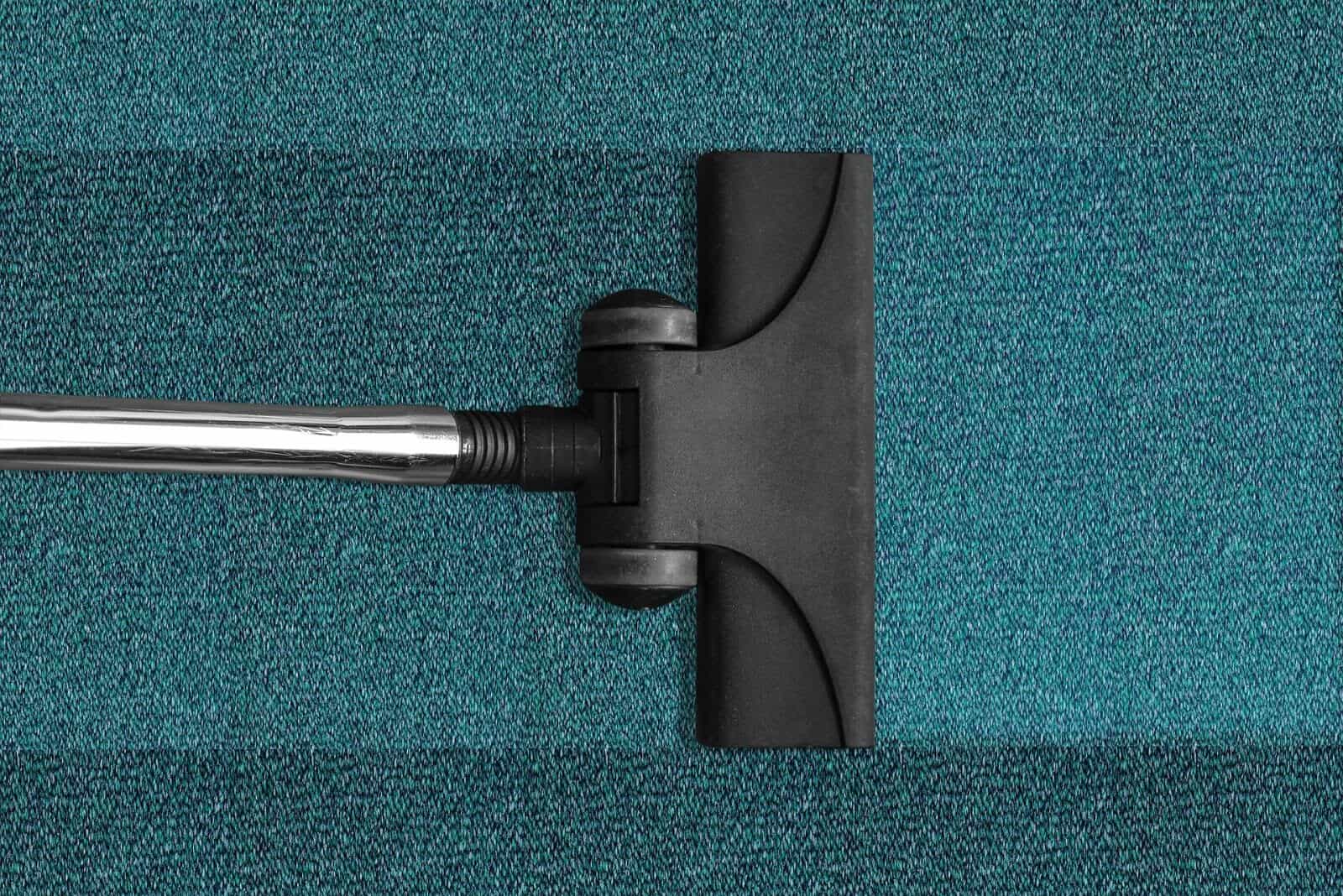 Vacuum cleaner on blue carpet