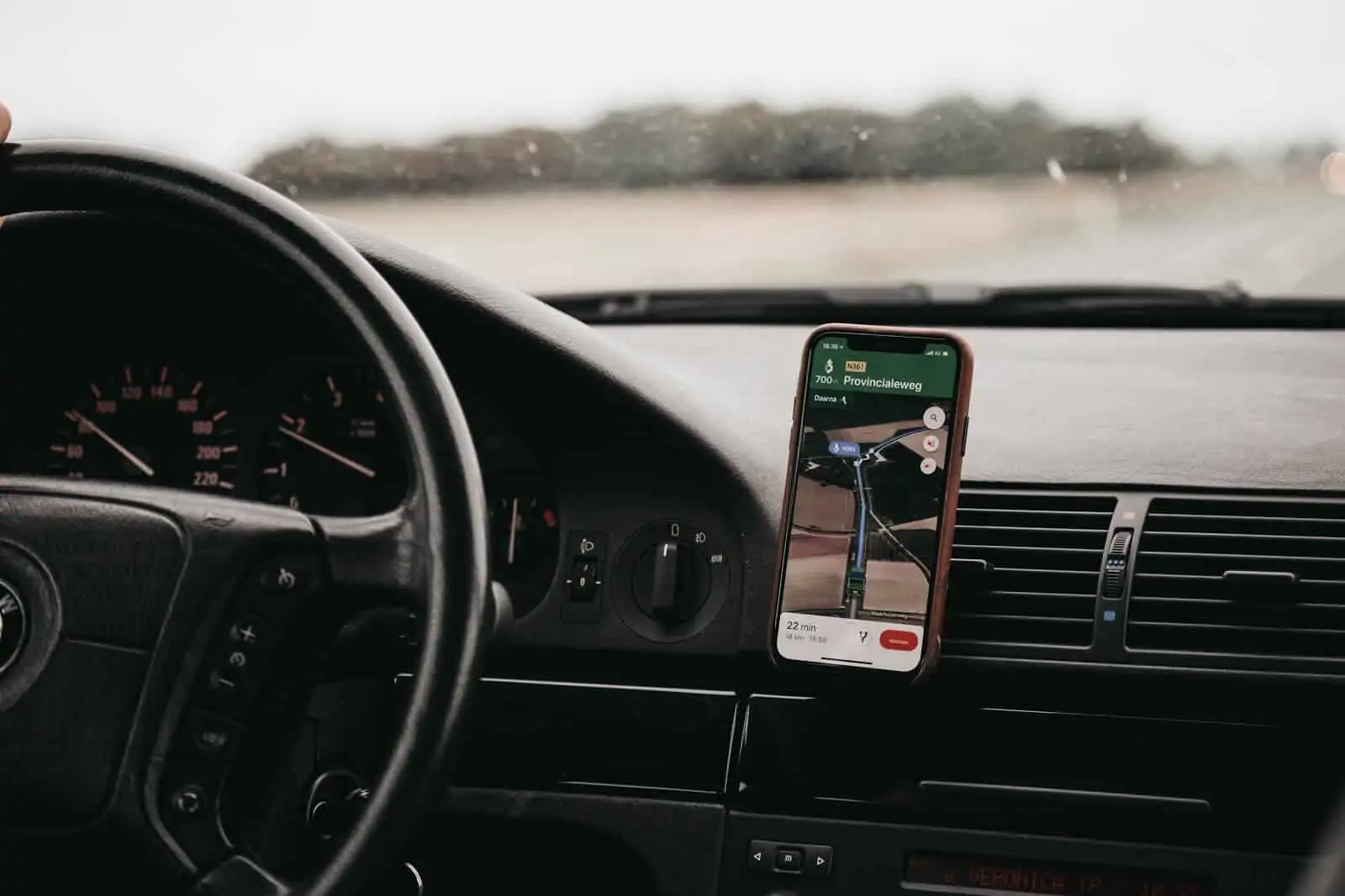 Google maps on a phone mounted on a dashboard