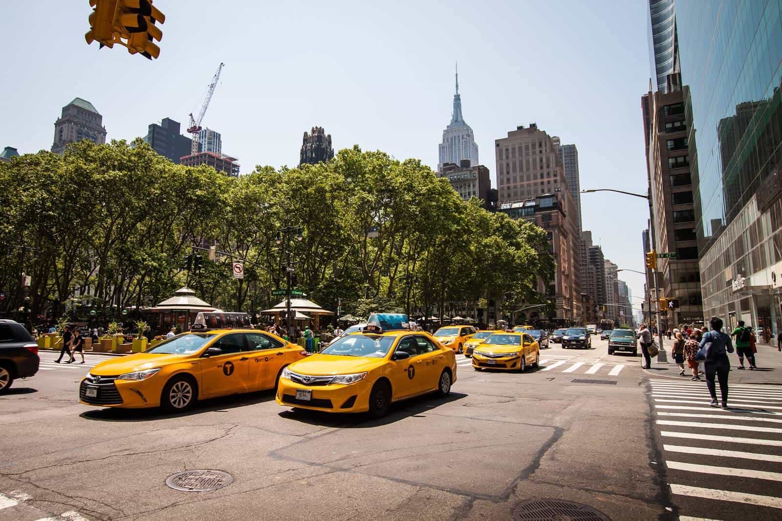 Taxis driving down Manhattan street
