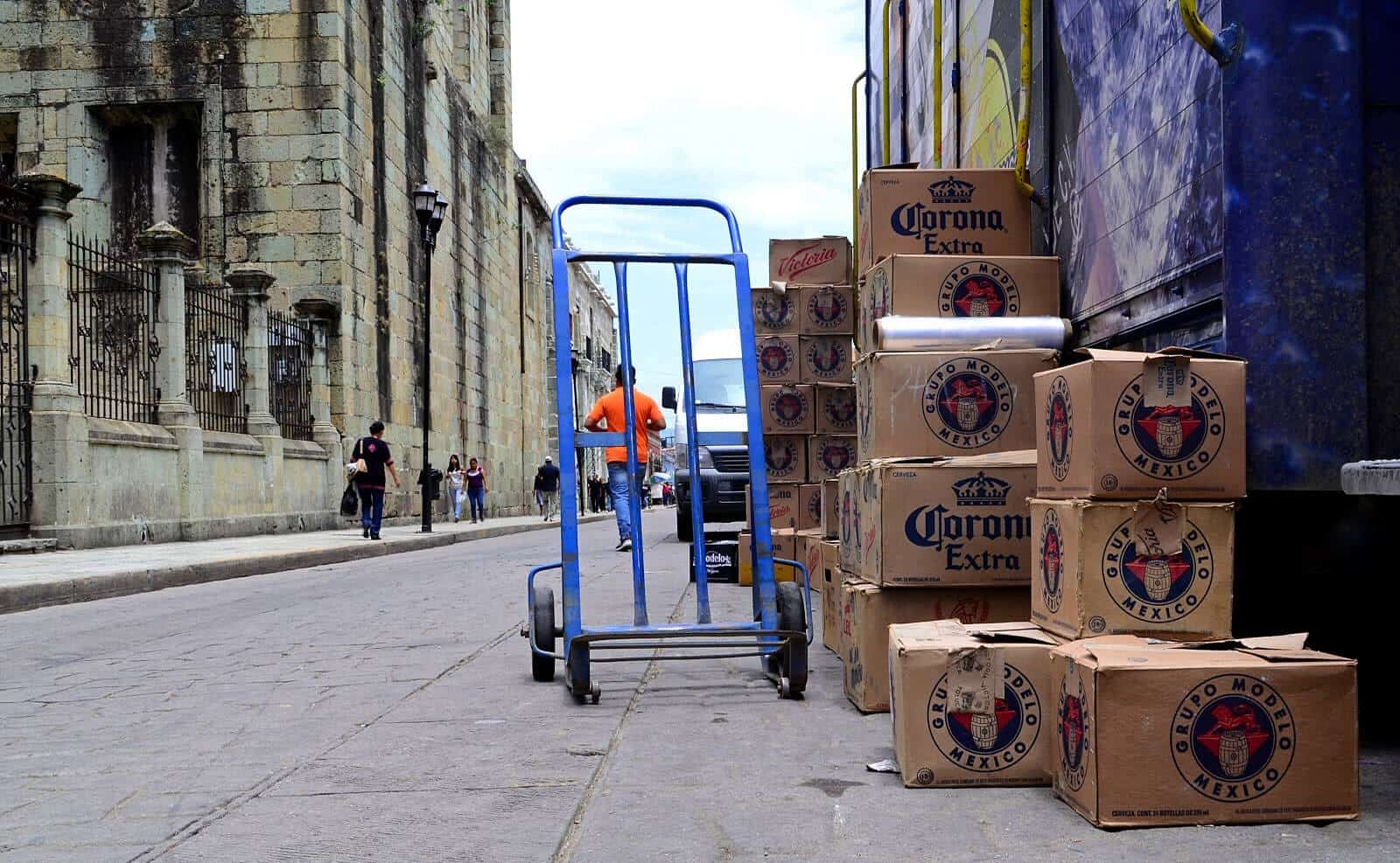 Boxes of Corona stacked up next to dolly