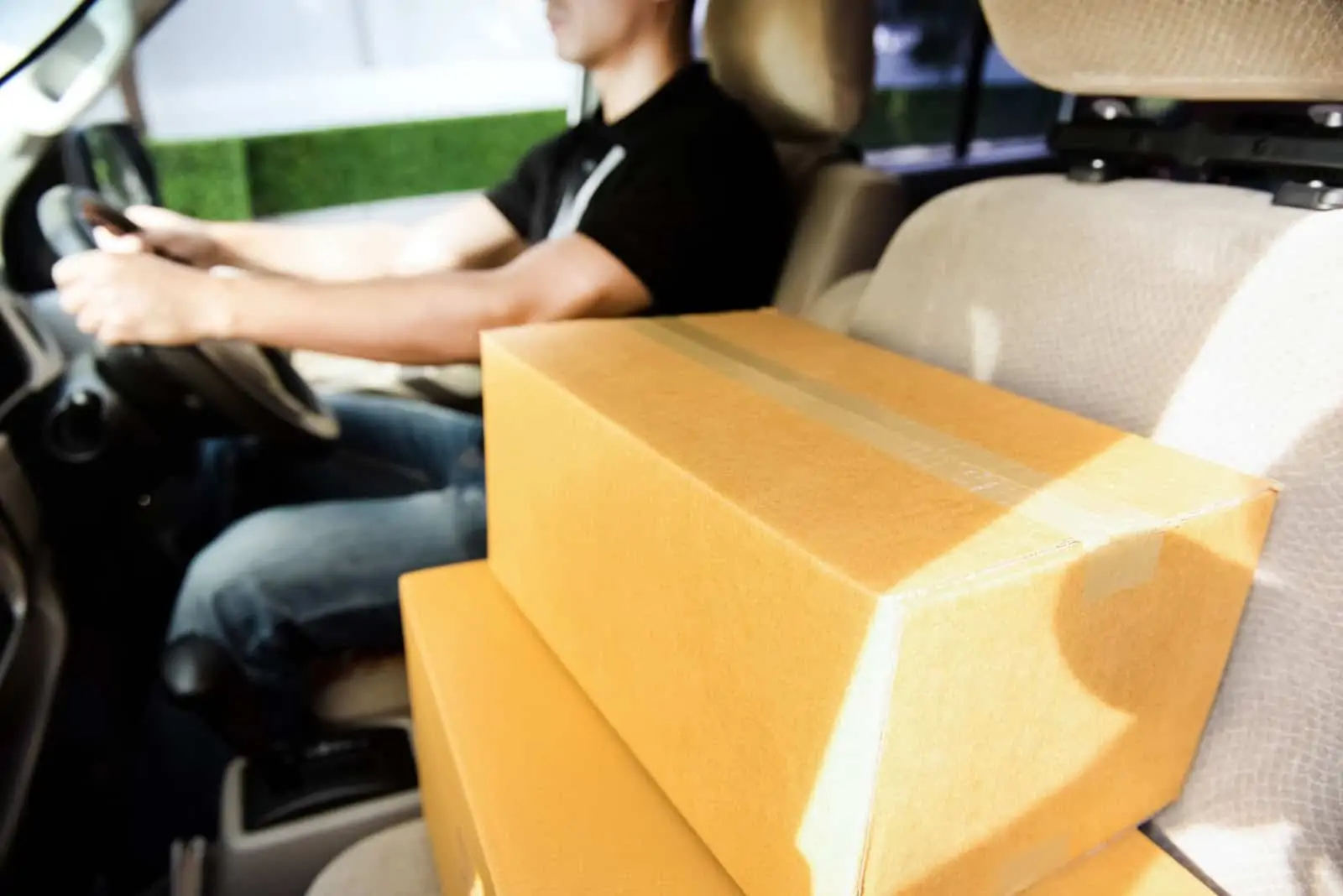 Packages stacked up in front seat of car