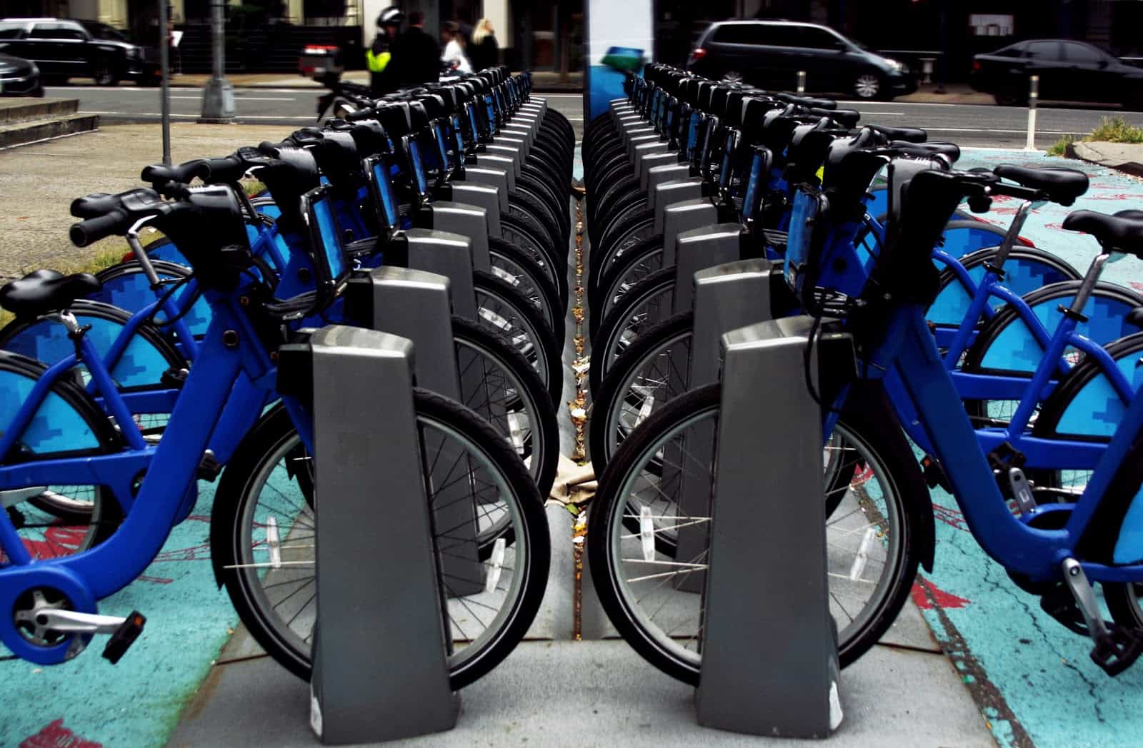 Blue bicycles lined up in city