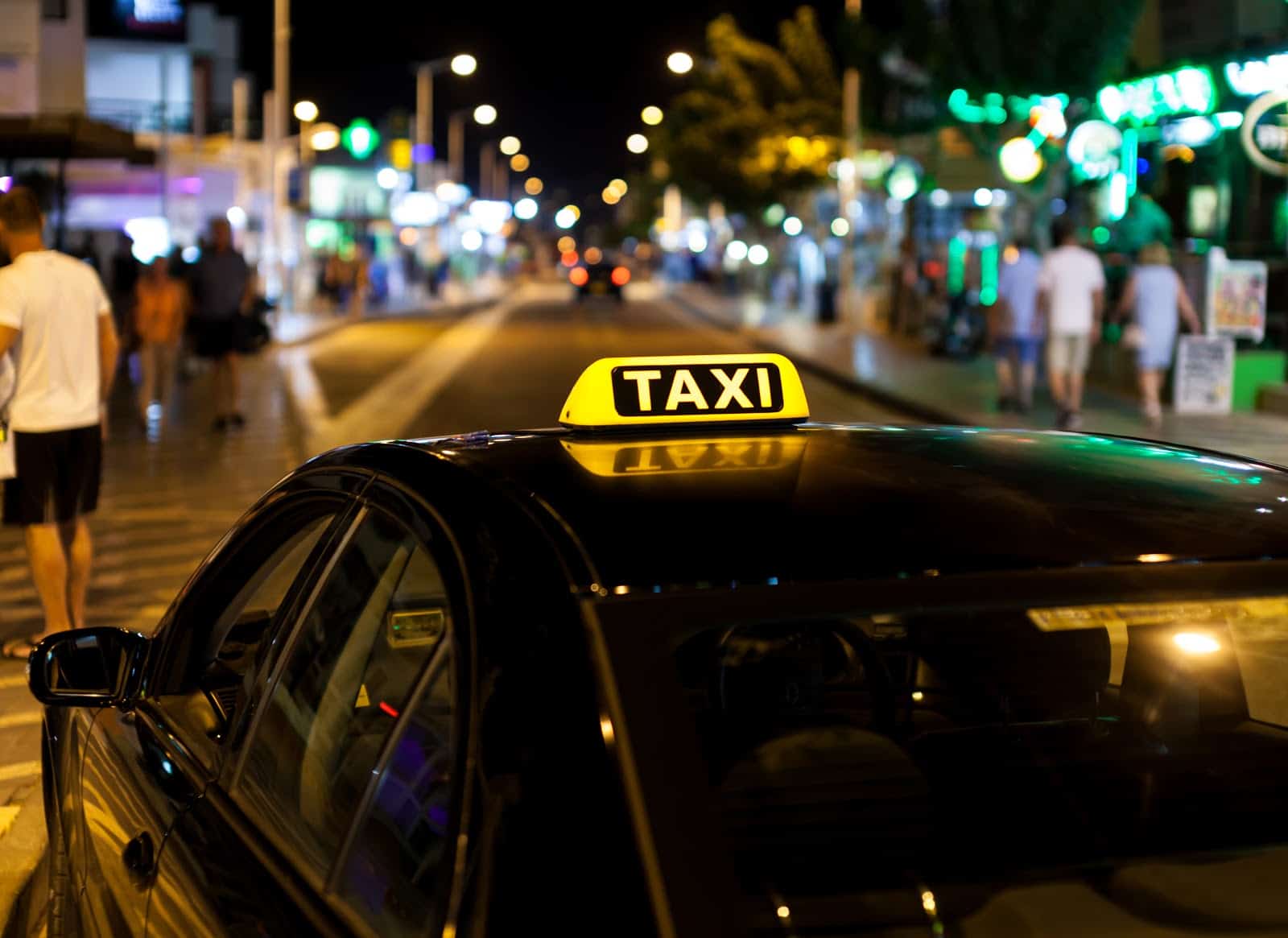 Curb promo code: a taxi in a busy downtown area
