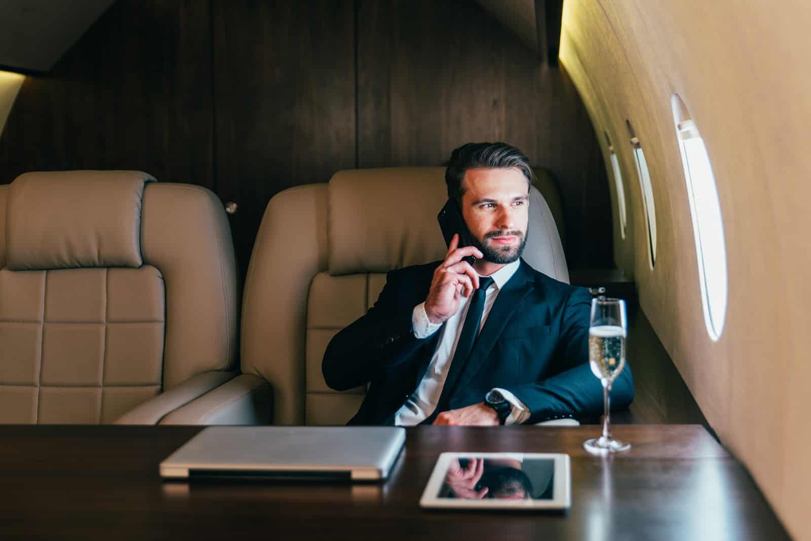 What is a chartered flight: A man in suit drinks champagne and flies on a private jet
