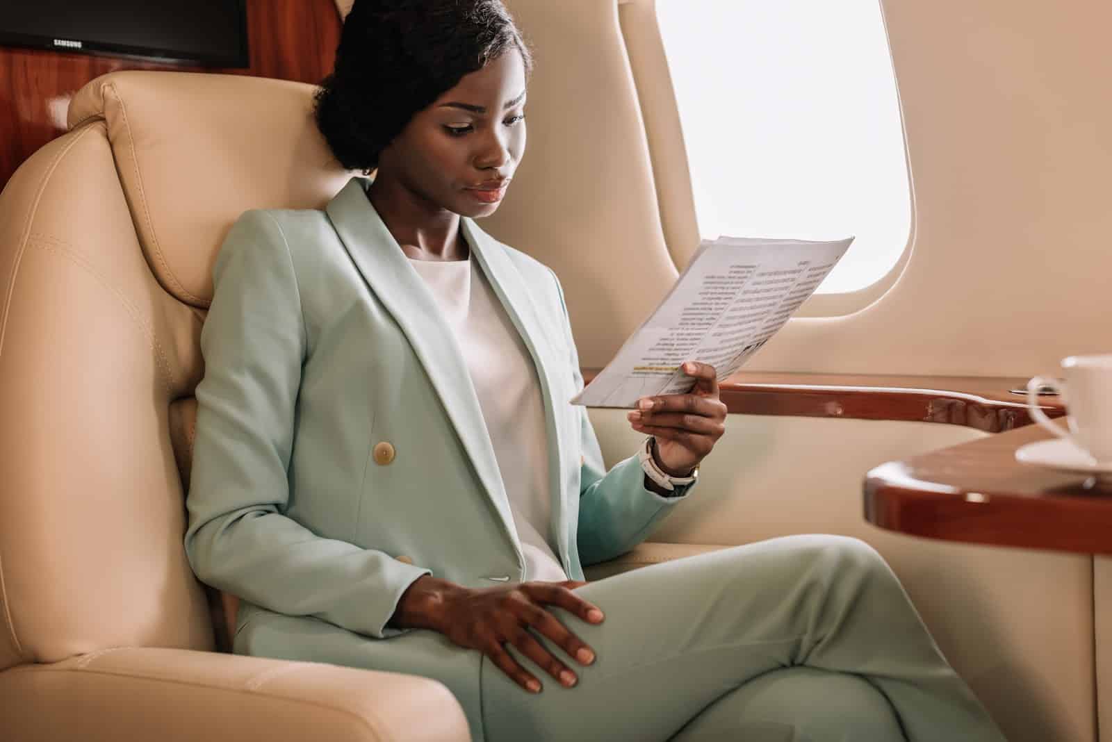 A woman looks at a menu on a private plane
