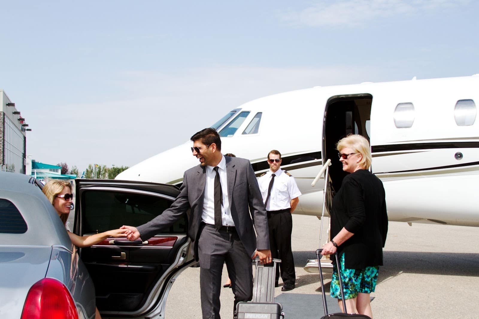 A wealthy family gets out of a private car and into a private jet