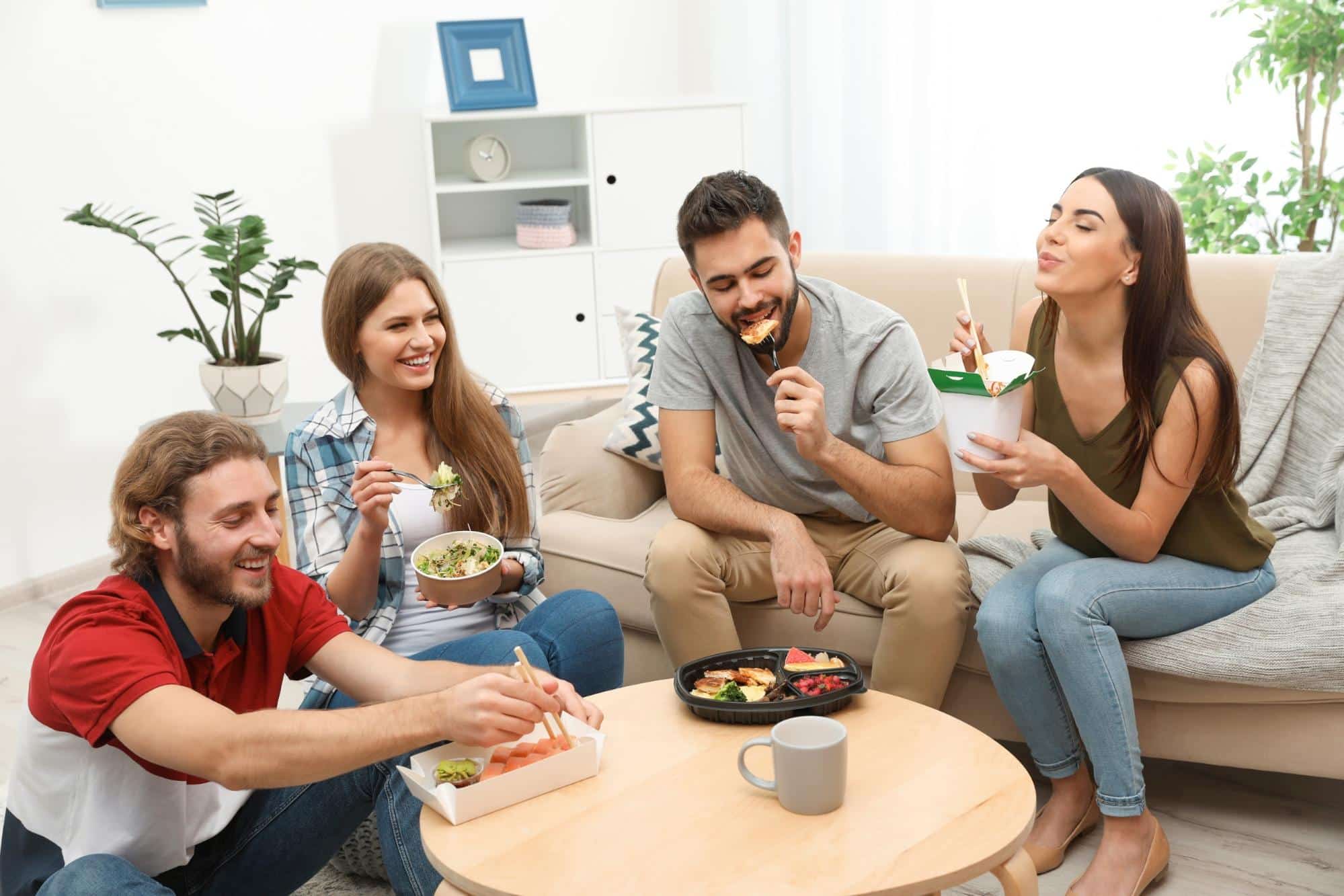 grubhub delivery fee: friends having lunch together in living room