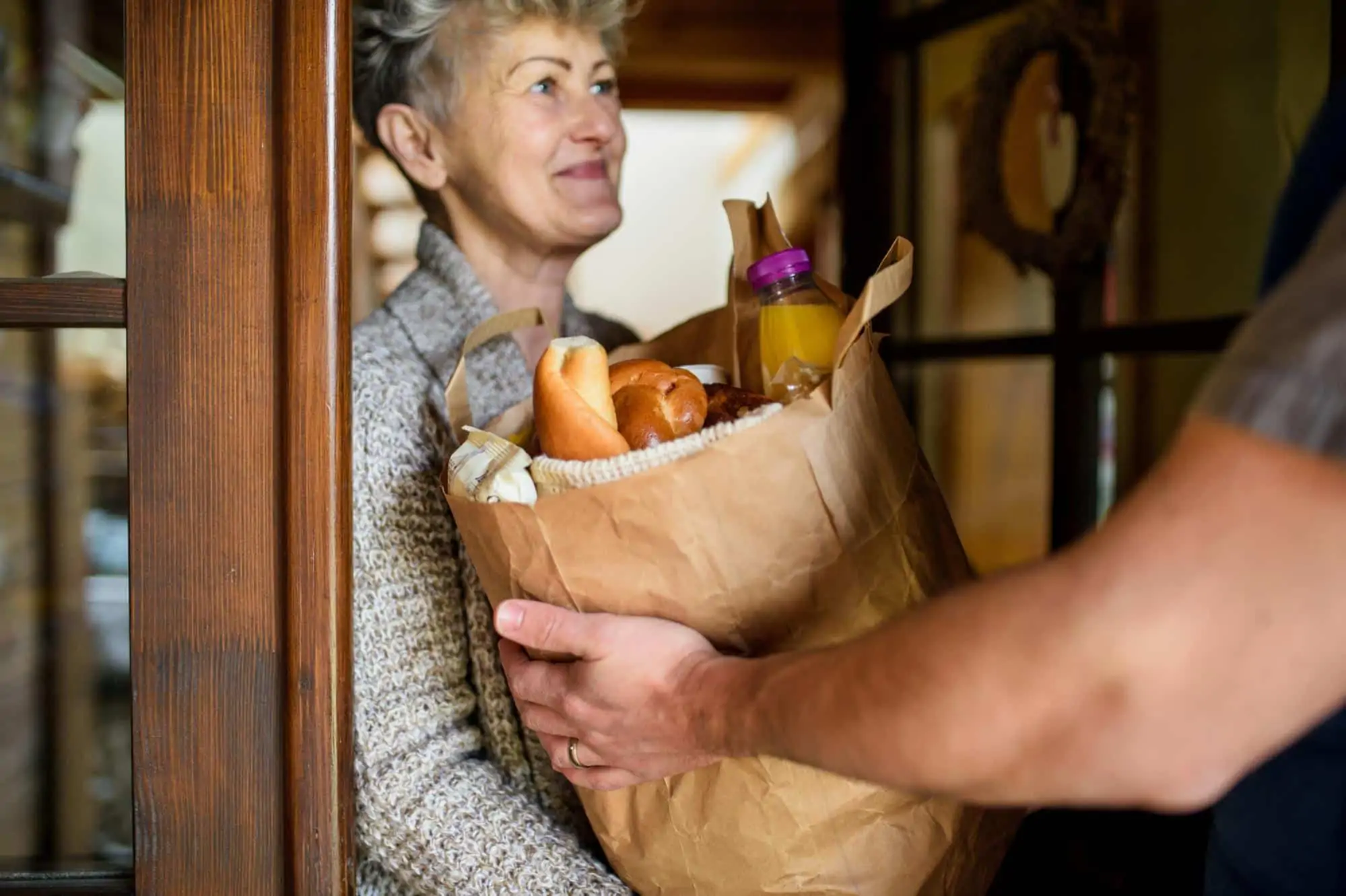 What is Prime Now: Courier delivering groceries to an old woman