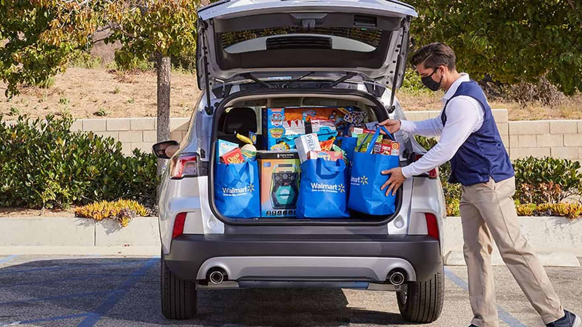 image showing walmart grocery pickup worker putting groceries in trunk