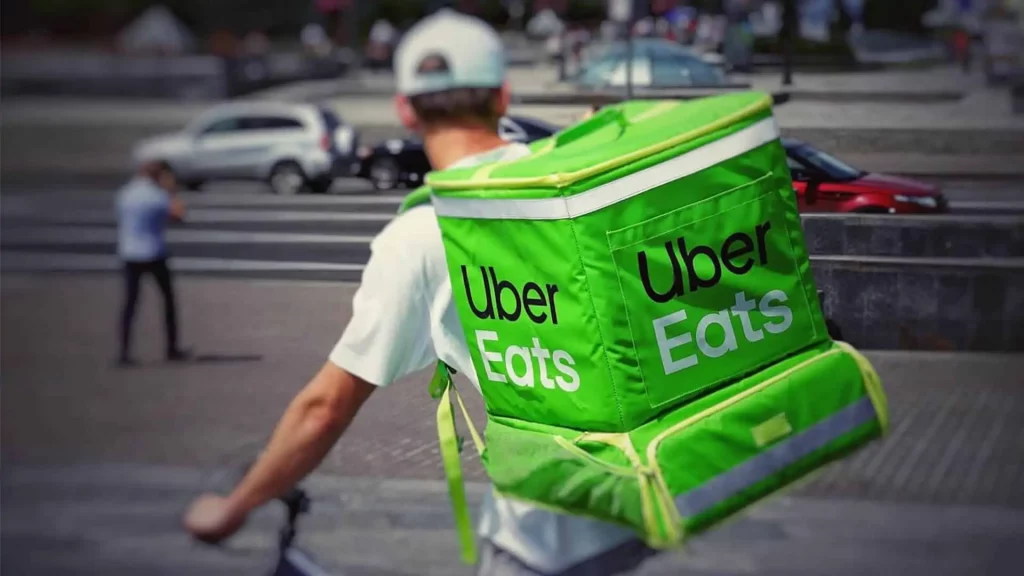 vector graphic showing an Uber Eats bike courier, one of the best food delivery services