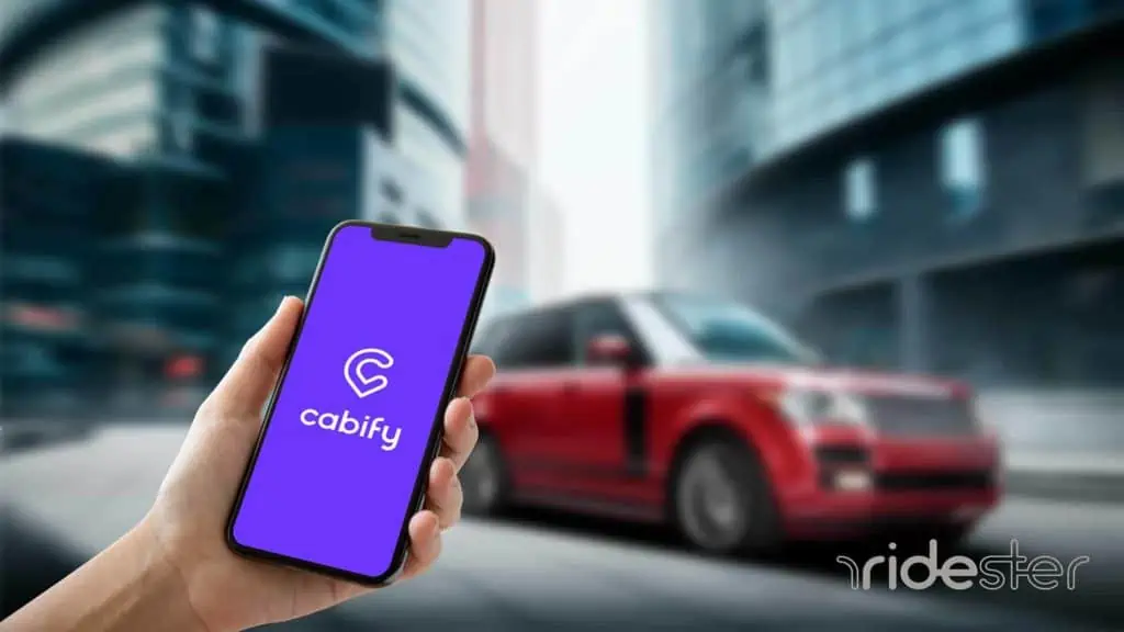 vector graphic showing a hand holding a smartphone with the cabify app on it in a city to show a person calling a ride