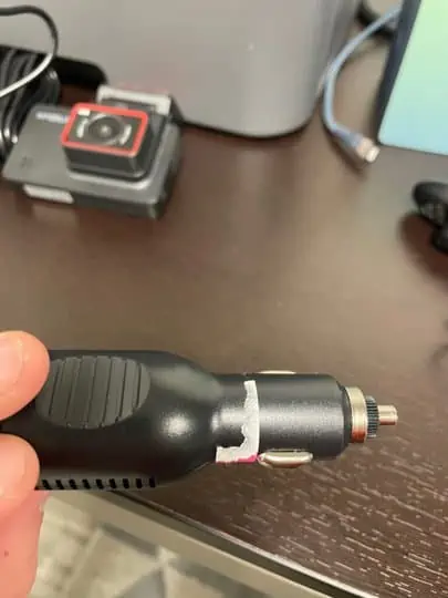 picture of a hand holding a kingslim d4 dash cam charger - for kingslim d4 dashcam review