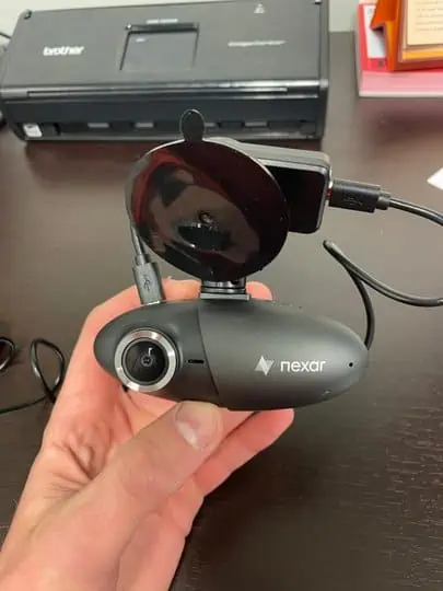 picture of a hand holding a nexar pro dash cam - for nexar pro review