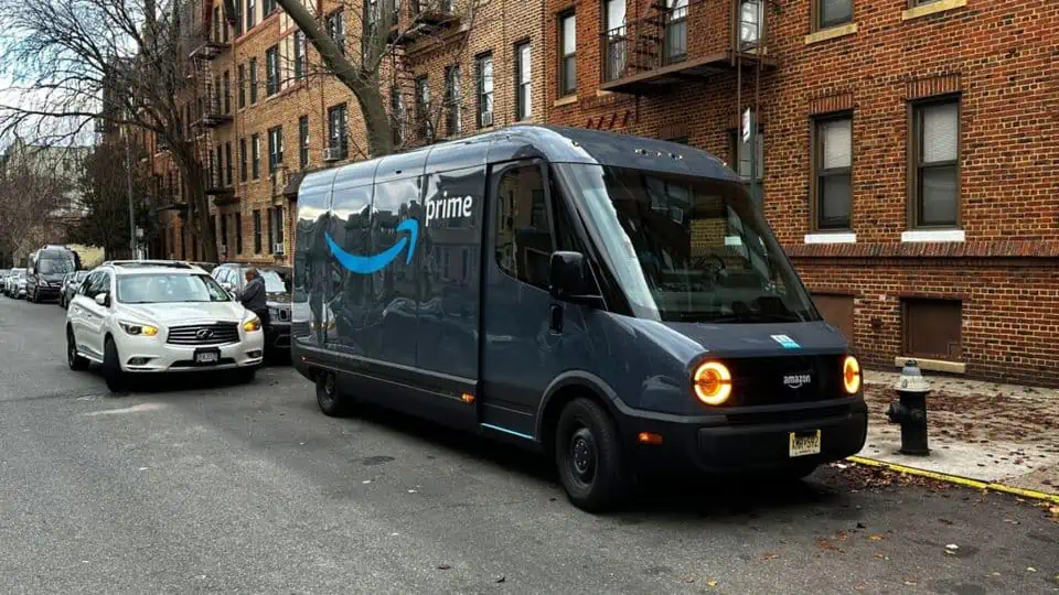 an image of an Amazon delivery truck delivering a package within a city