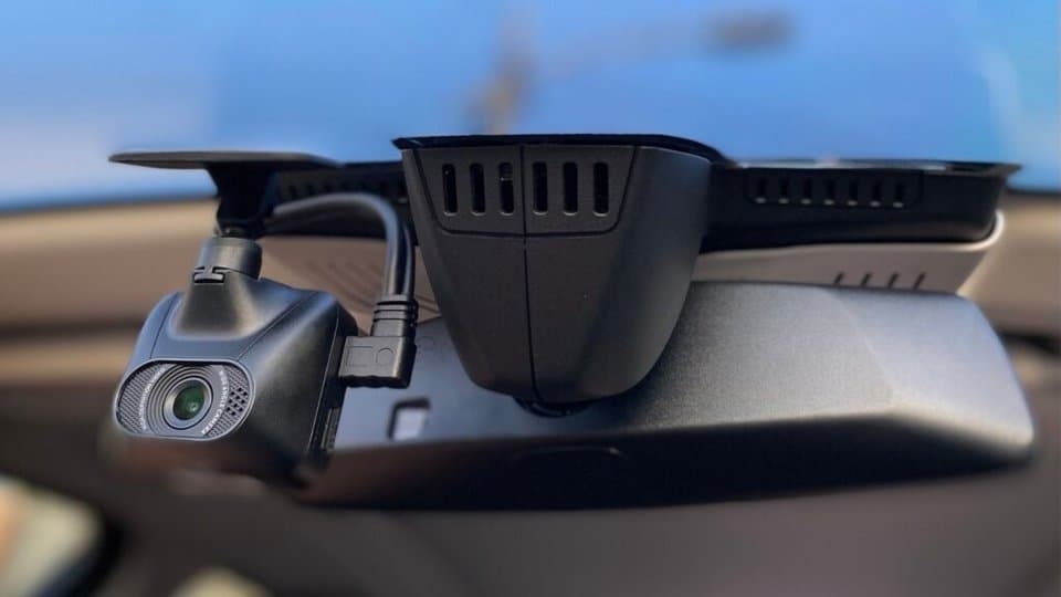 an image of a mirror dash cam mounted to the front windshield of a vehicle